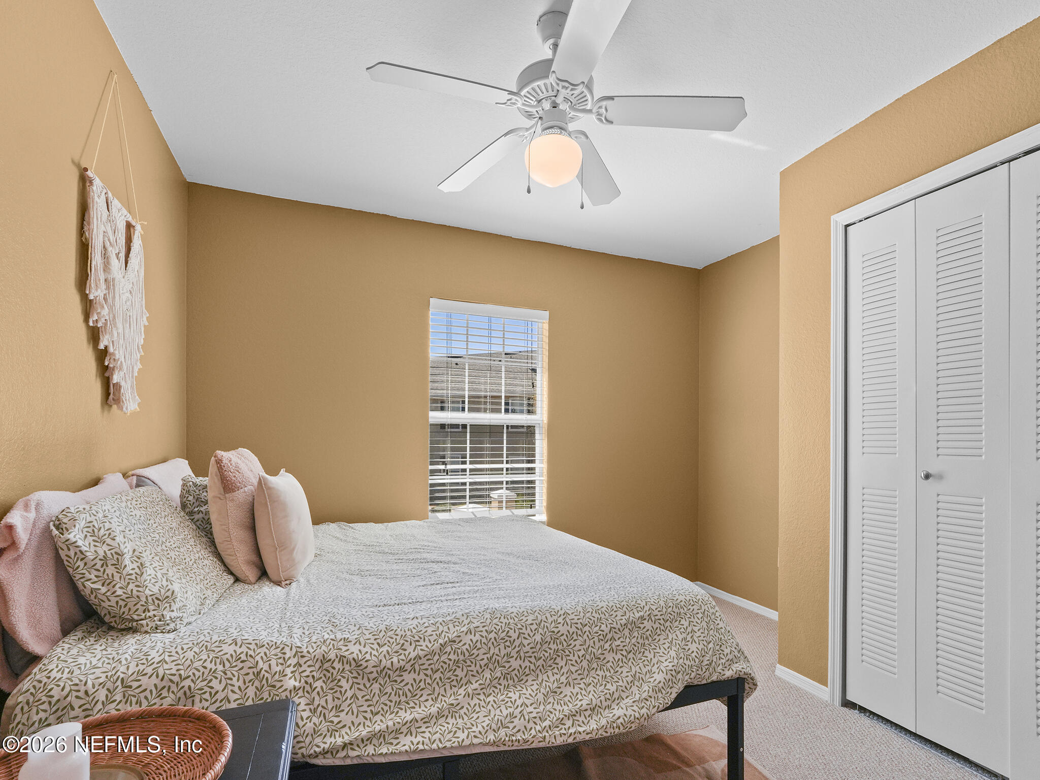 712 Lighthouse Road, Unit 712 Panama City Beach, FL 32407 - Photo 17 of 42 a bedroom with a bed and ceiling fan