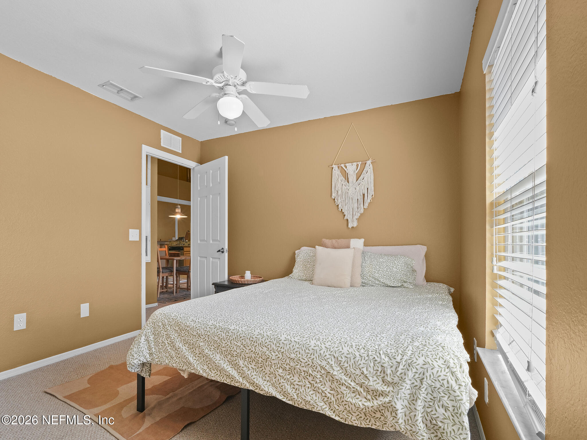 712 Lighthouse Road, Unit 712 Panama City Beach, FL 32407 - Photo 19 of 42 a bedroom with a bed and a chandelier