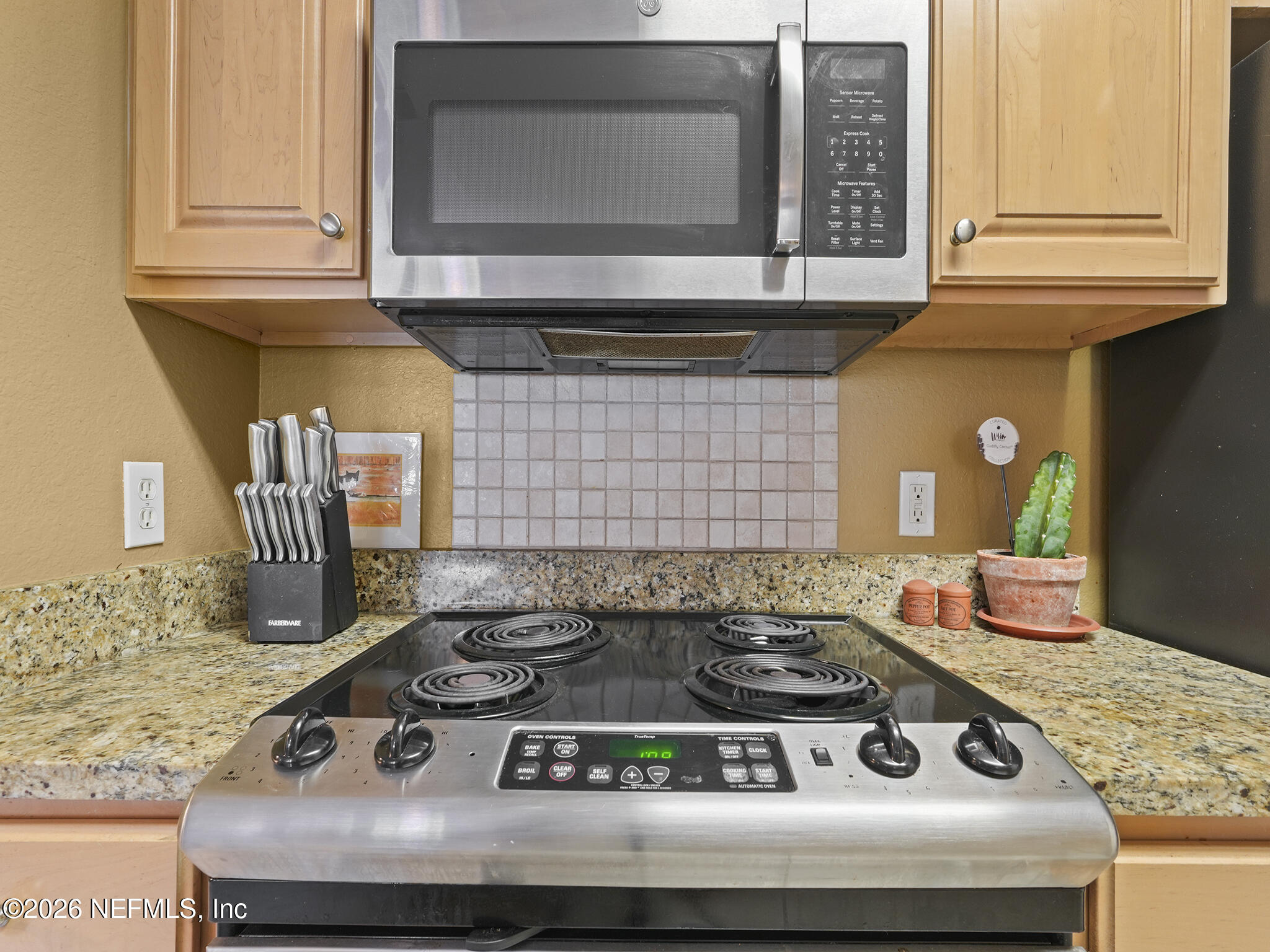 712 Lighthouse Road, Unit 712 Panama City Beach, FL 32407 - Photo 21 of 42 a stove top oven sitting inside of a kitchen