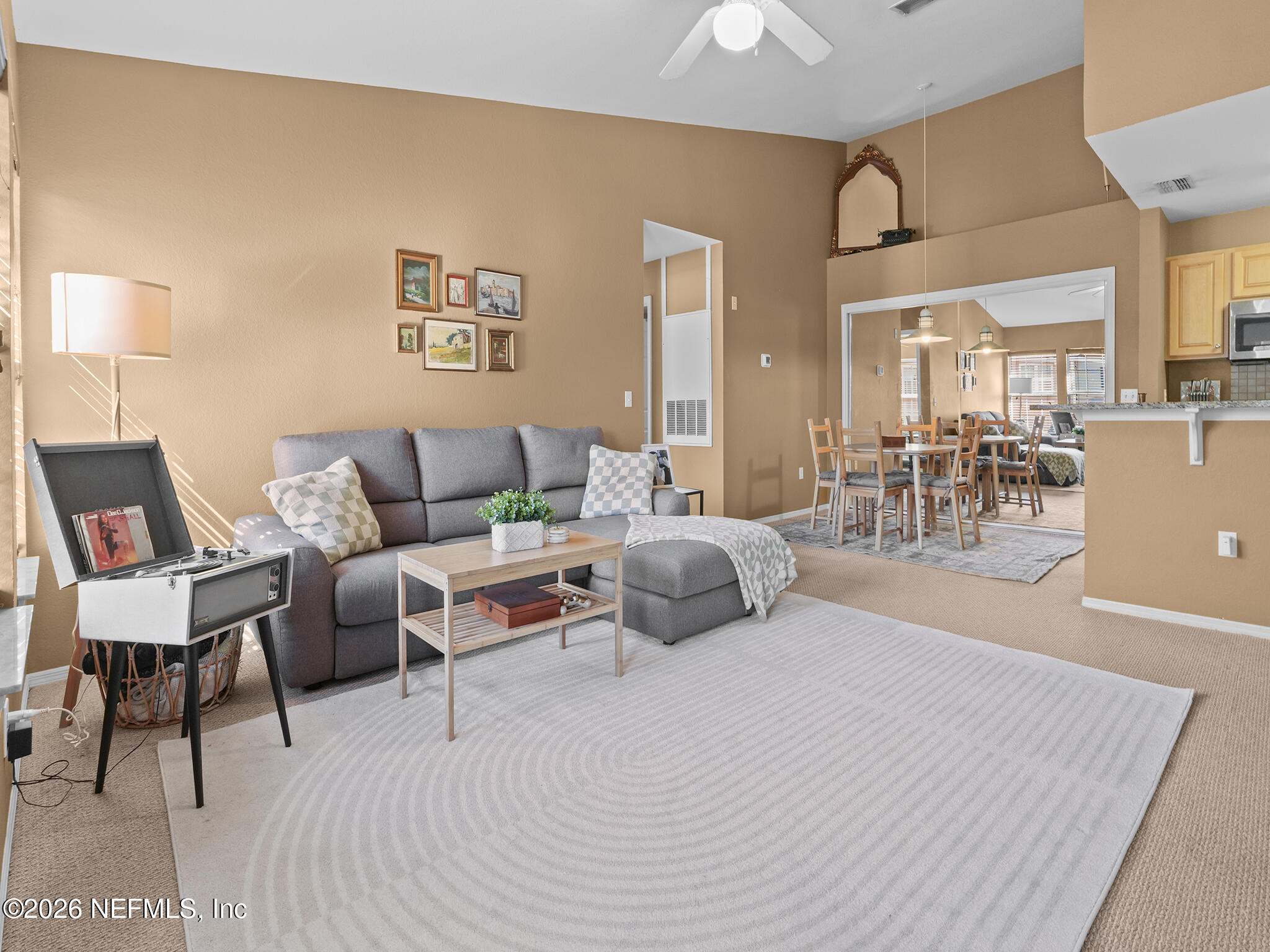 712 Lighthouse Road, Unit 712 Panama City Beach, FL 32407 - Photo 27 of 42 a living room with furniture and a table