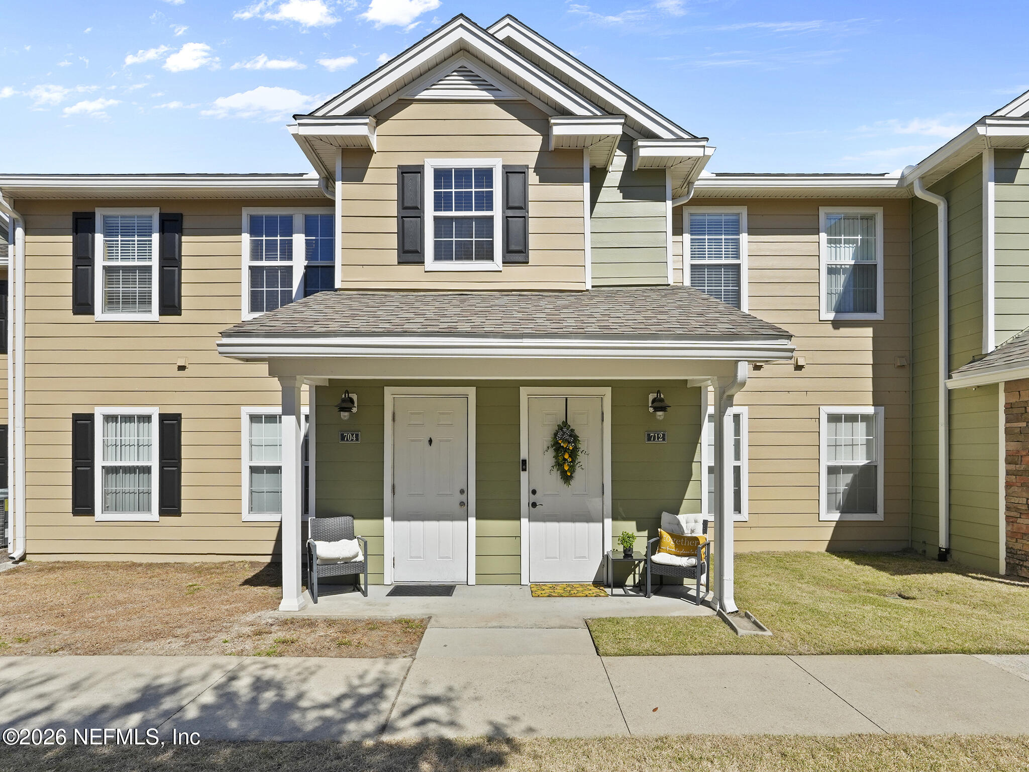 712 Lighthouse Road, Unit 712 Panama City Beach, FL 32407 - Photo 3 of 42 a front view of a house with a yard