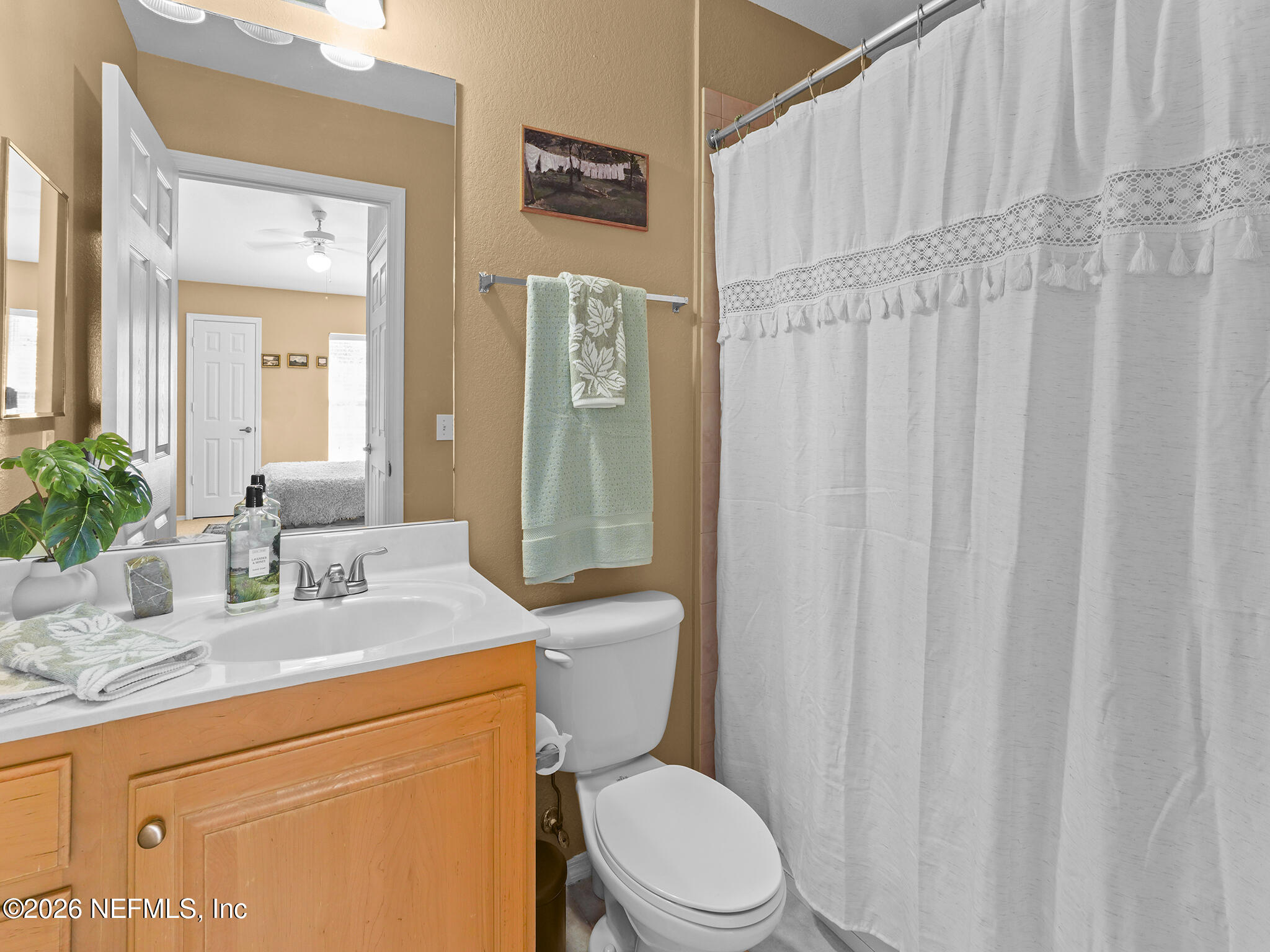 712 Lighthouse Road, Unit 712 Panama City Beach, FL 32407 - Photo 32 of 42 a bathroom with a granite countertop toilet sink and mirror