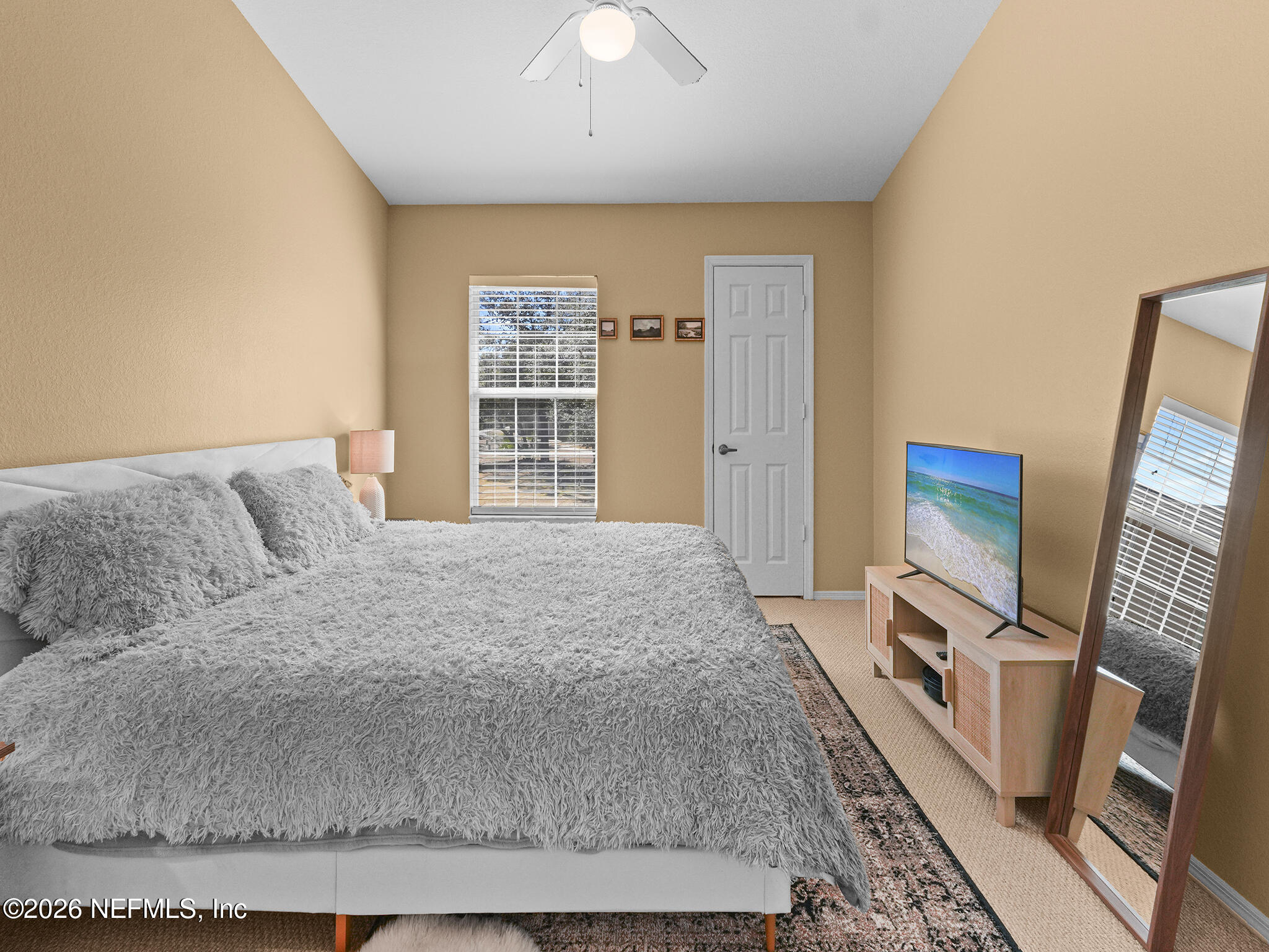 712 Lighthouse Road, Unit 712 Panama City Beach, FL 32407 - Photo 33 of 42 a spacious bedroom with a bed and a flat screen tv
