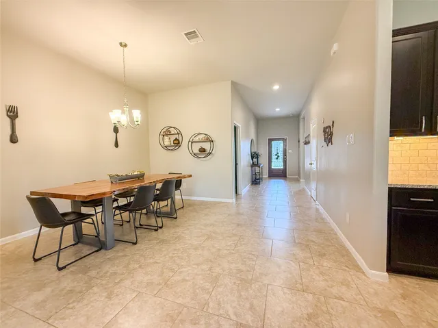 a kitchen with stainless steel appliances kitchen island granite countertop a refrigerator and cabinets