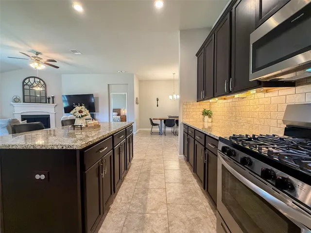 a view of a livingroom and a dining room with furniture