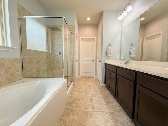 a bathroom with a bathtub and shower