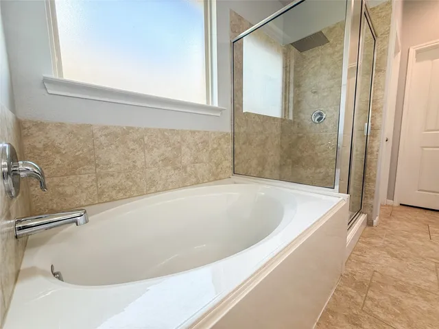 a living room with furniture kitchen view and a wooden floor