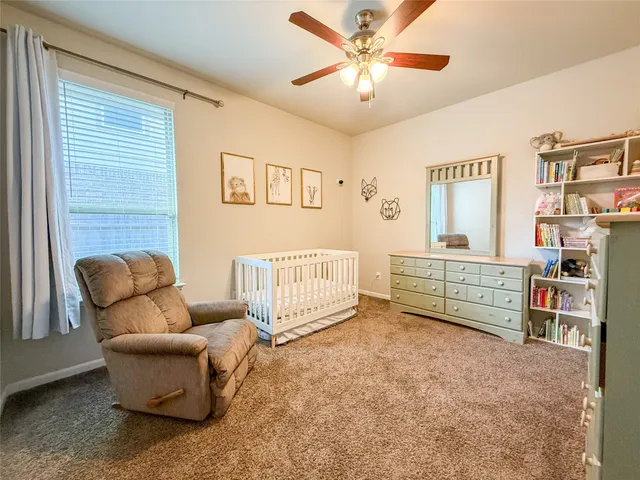 a bedroom with furniture and a baby crib