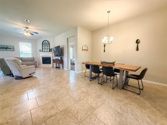 a view of a dining room with furniture and chandelier