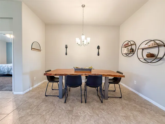a dining room with a wooden table and chairs