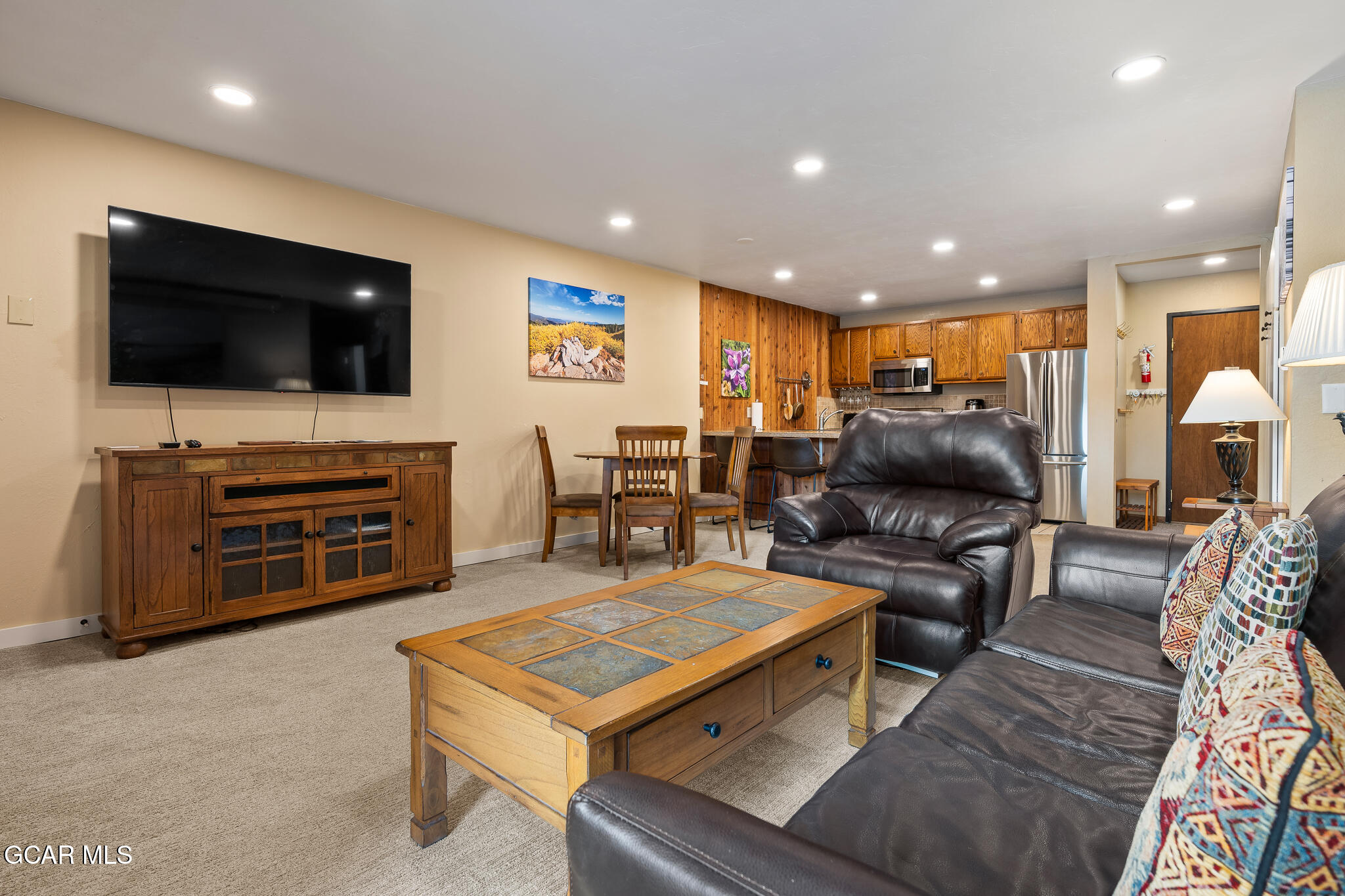 a living room with furniture and a flat screen tv
