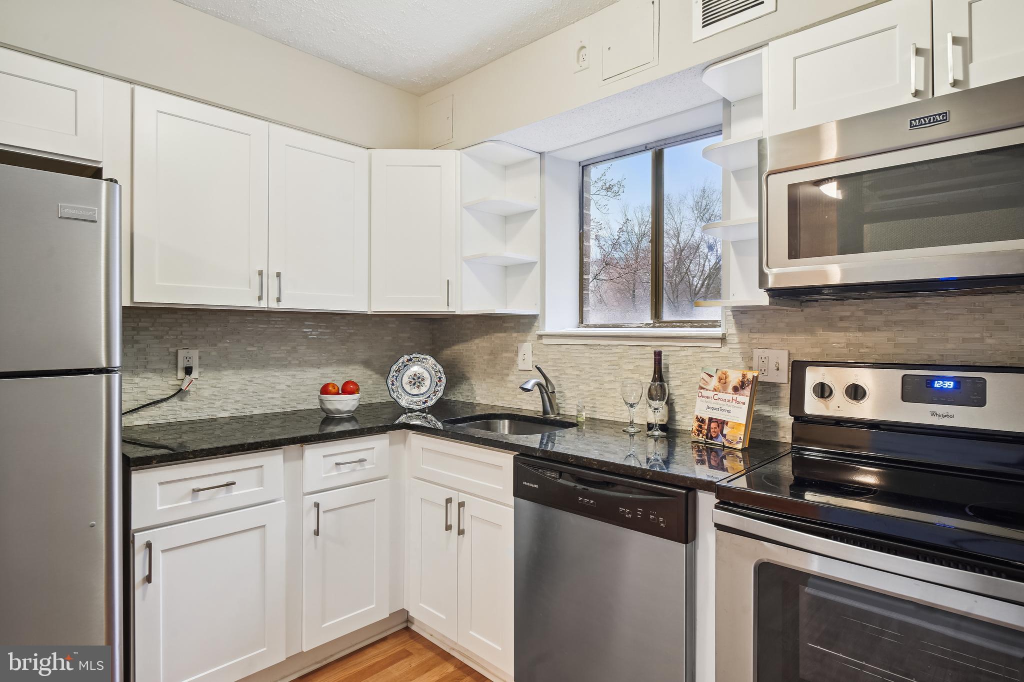 17817 Buehler Road, Unit 96 Olney, MD 20832 - Photo 12 of 38 a kitchen with stainless steel appliances granite countertop a sink and a stove