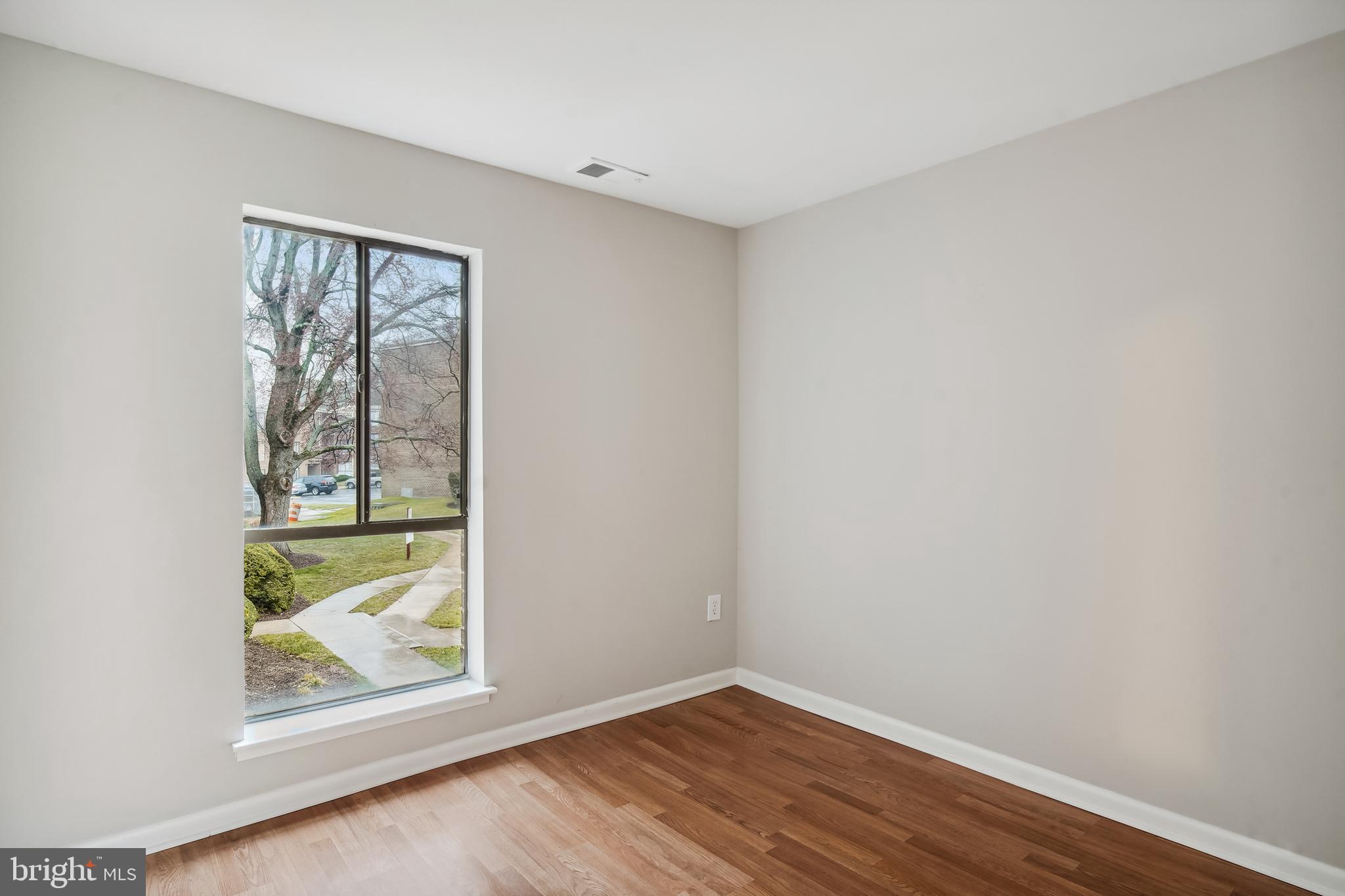 17817 Buehler Road, Unit 96 Olney, MD 20832 - Photo 21 of 38 an empty room with wooden floor and windows