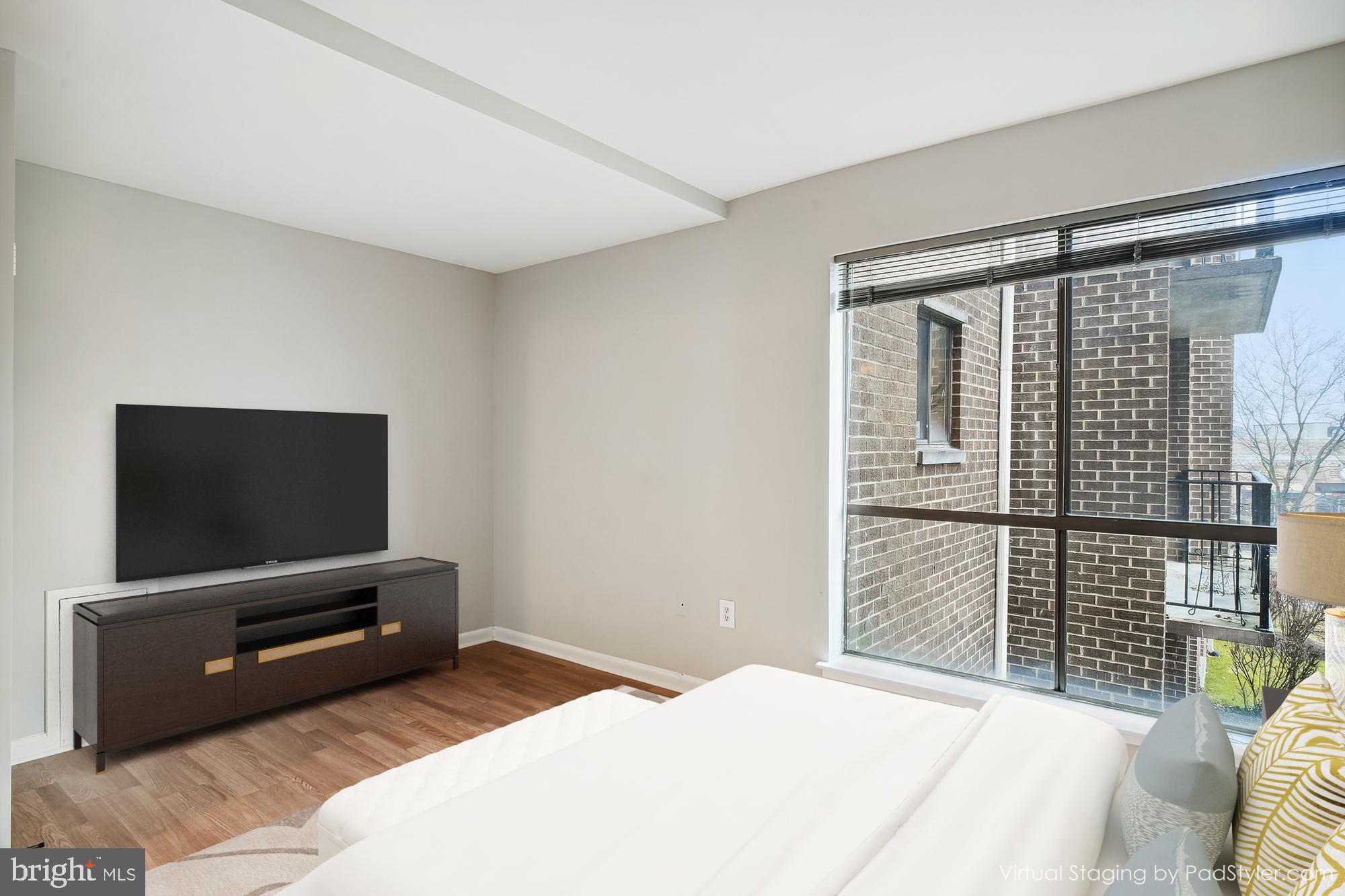 17817 Buehler Road, Unit 96 Olney, MD 20832 - Photo 7 of 38 a bedroom with a bed and a flat screen tv