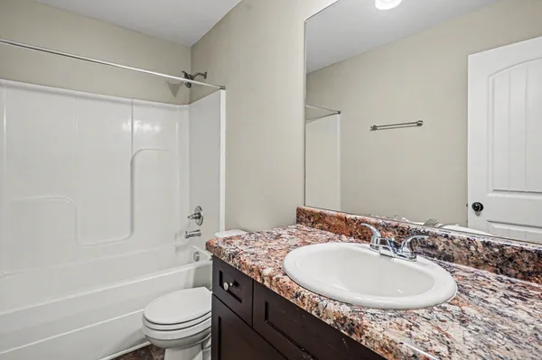 a bathroom with a yard and a wooden fence