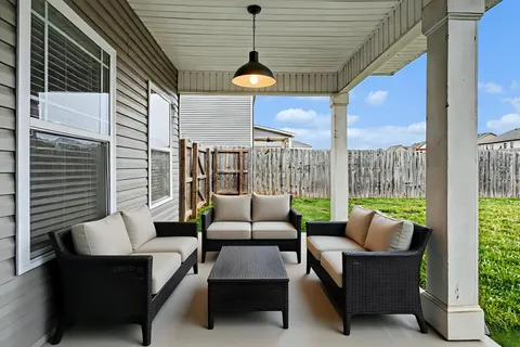 a balcony with furniture and a potted plant
