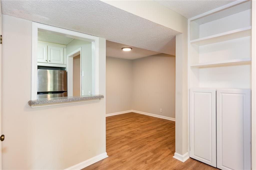 591 Emory Oaks Way, Unit 591 Decatur, GA 30033 - Photo 15 of 33 a view of an empty room with wooden floor and a window