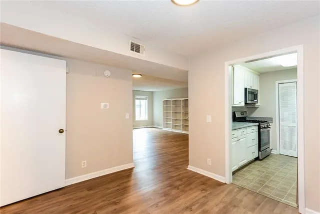 a kitchen with granite countertop cabinets stainless steel appliances a sink and a window
