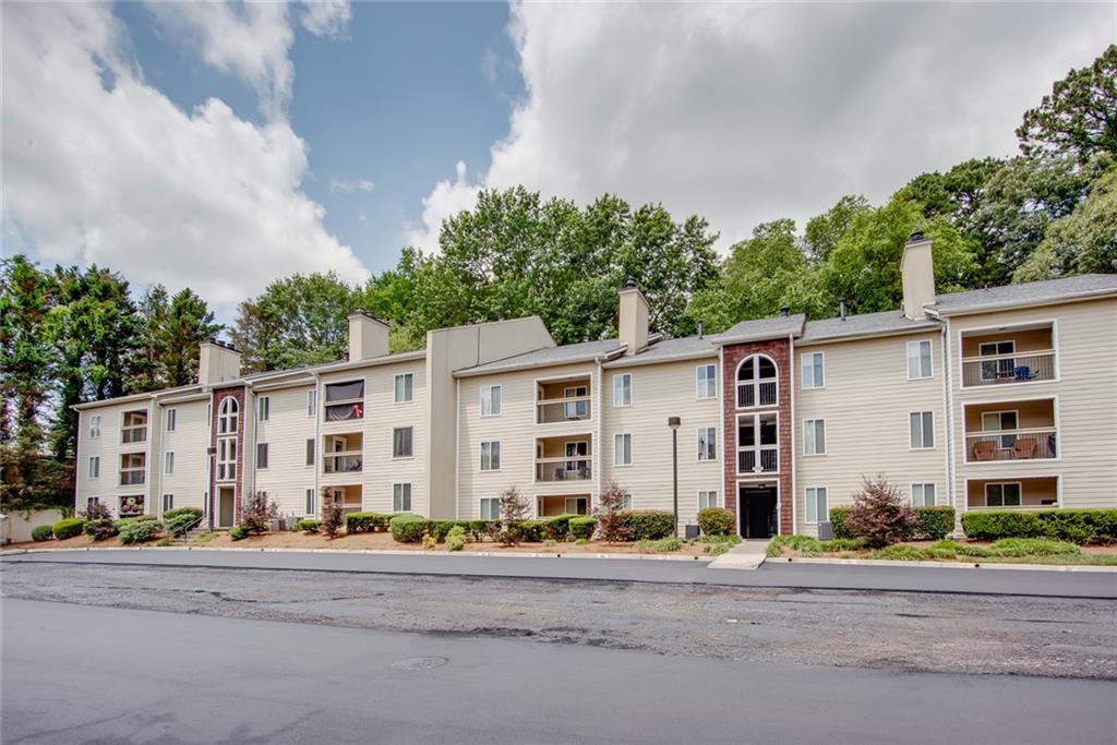 591 Emory Oaks Way, Unit 591 Decatur, GA 30033 - Photo 2 of 33 front view of a building with a street