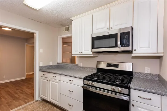 a kitchen with appliances and cabinets