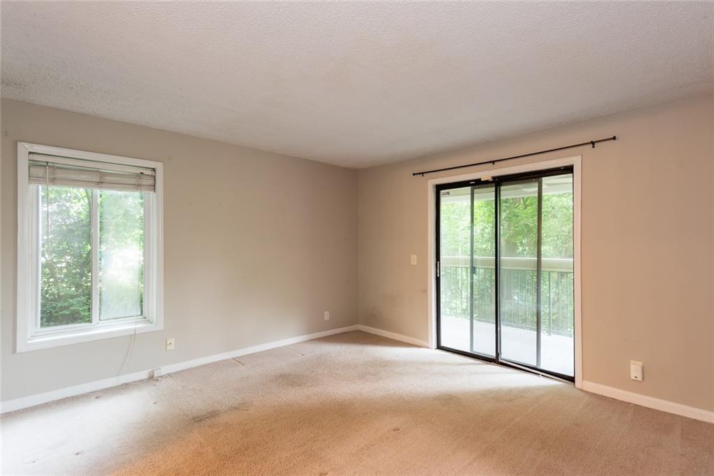 591 Emory Oaks Way, Unit 591 Decatur, GA 30033 - Photo 25 of 33 a view of an empty room with a window
