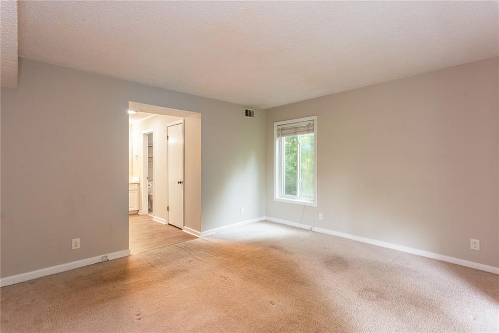591 Emory Oaks Way, Unit 591 Decatur, GA 30033 - Photo 26 of 33 an empty room with windows and closet