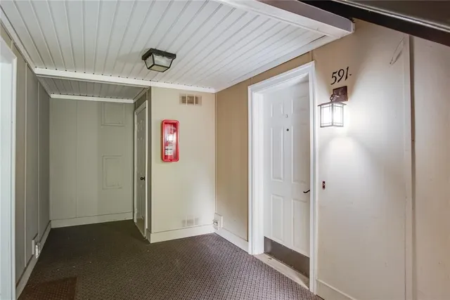 an empty room with wooden floor and closet