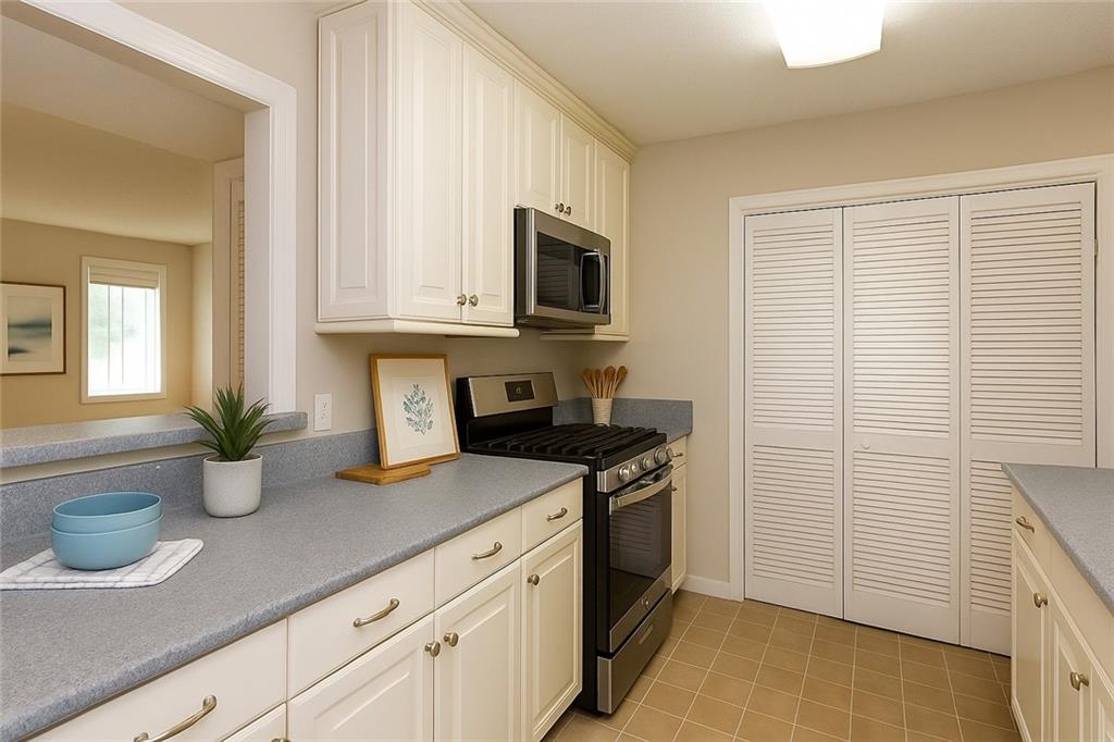 591 Emory Oaks Way, Unit 591 Decatur, GA 30033 - Photo 6 of 33 a kitchen with stainless steel appliances granite countertop a sink a stove and a microwave