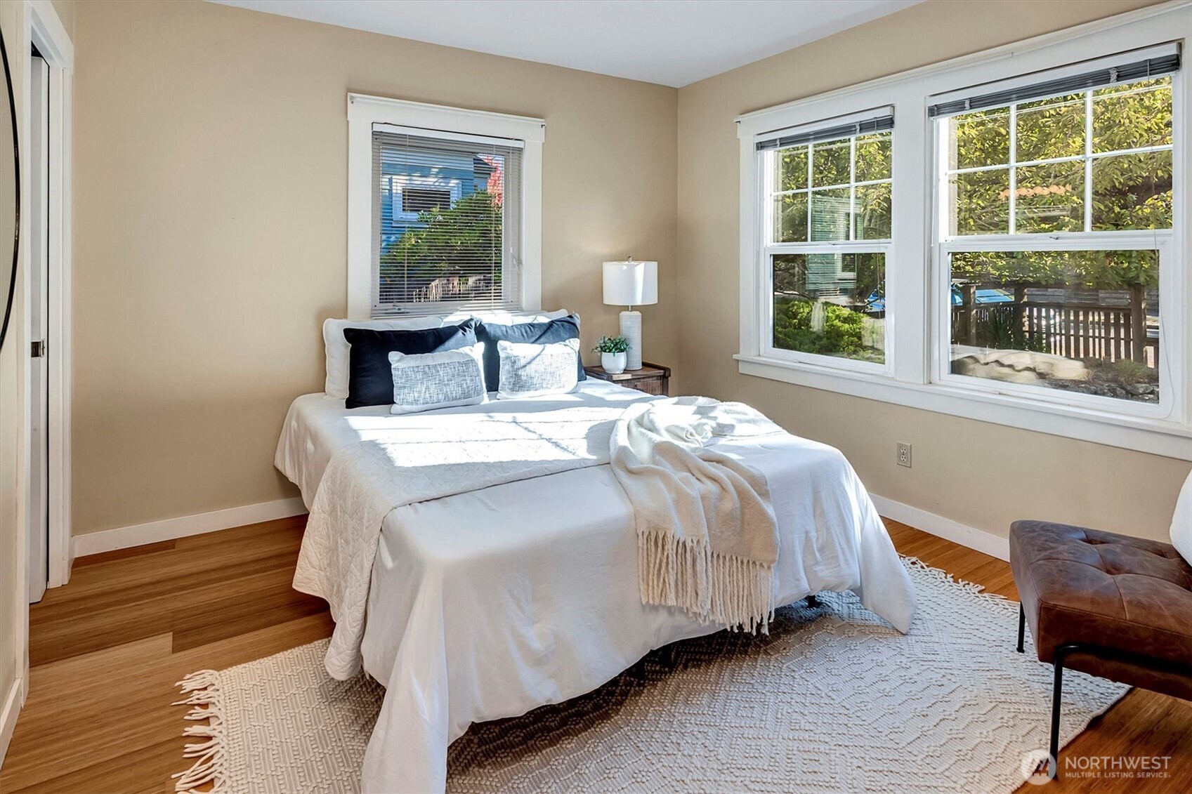 6021 45th Avenue Southwest Seattle, WA 98136 - Photo 6 of 18 a bed sitting in a bedroom next to a window