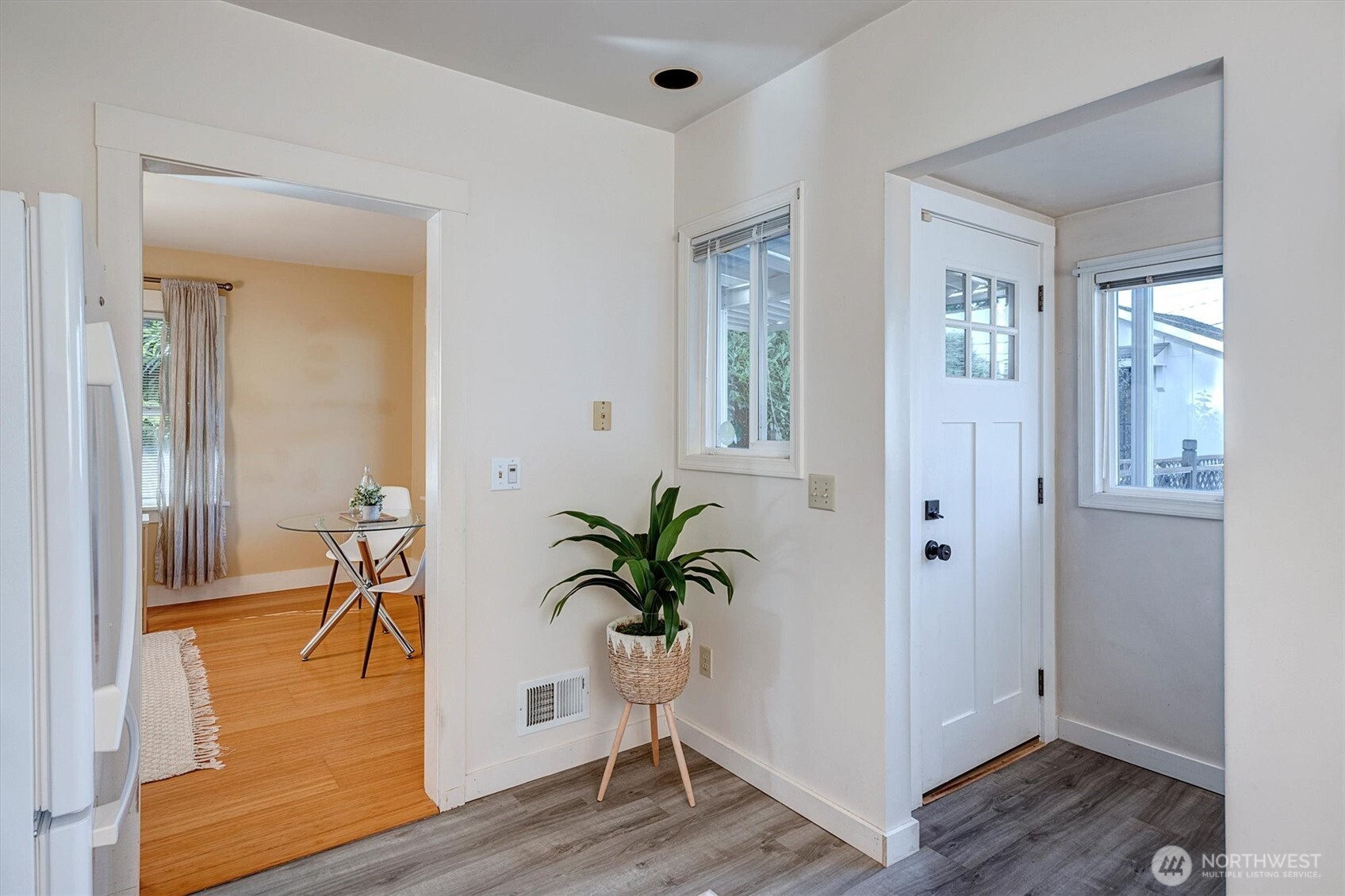 6021 45th Avenue Southwest Seattle, WA 98136 - Photo 9 of 18 a view of a hallway with wooden floor and a potted plant