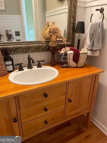 a living room with furniture gym equipment and large windows