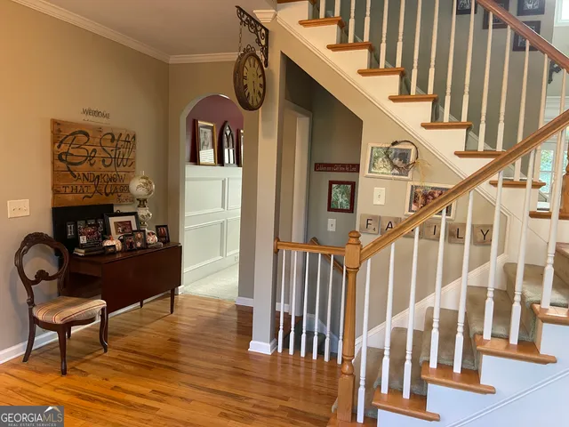 a living room with furniture kitchen view and a large window
