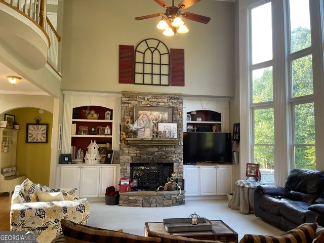 a view of living room kitchen with granite countertop furniture and fireplace