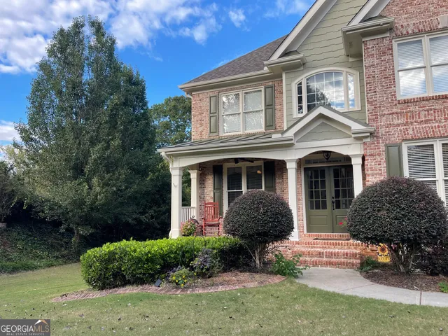 a front view of a house with a garden