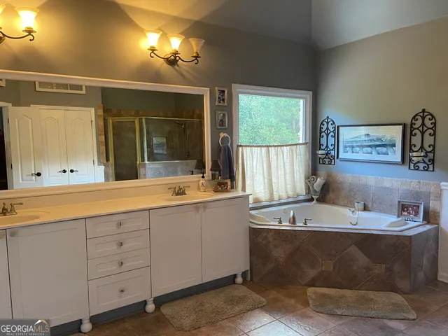 a bedroom with a bed and a ceiling fan