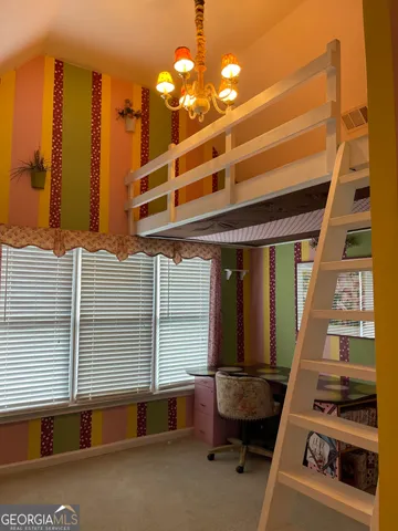 a hallway with a large window and a couch