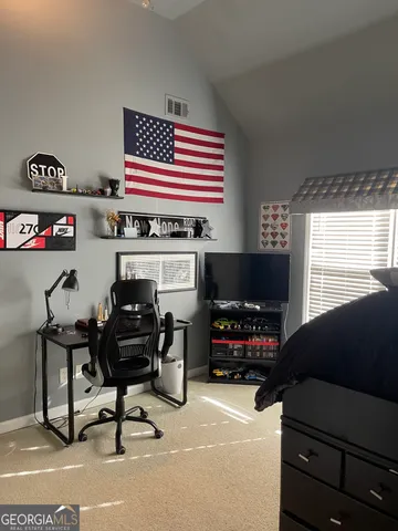 a view of a balcony with yard & wooden fence
