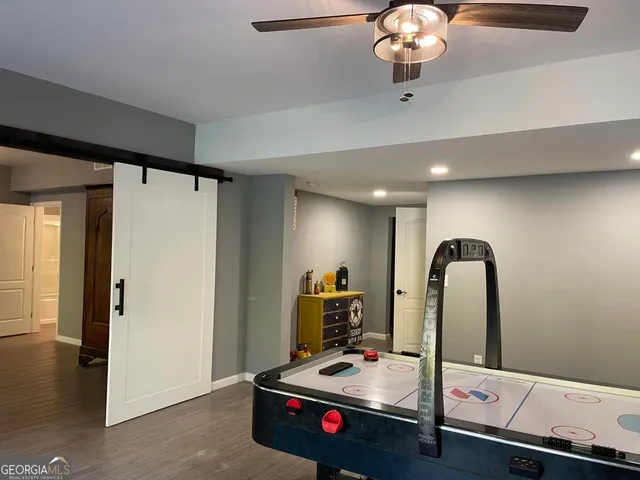 a view of a big building with a big yard and large trees