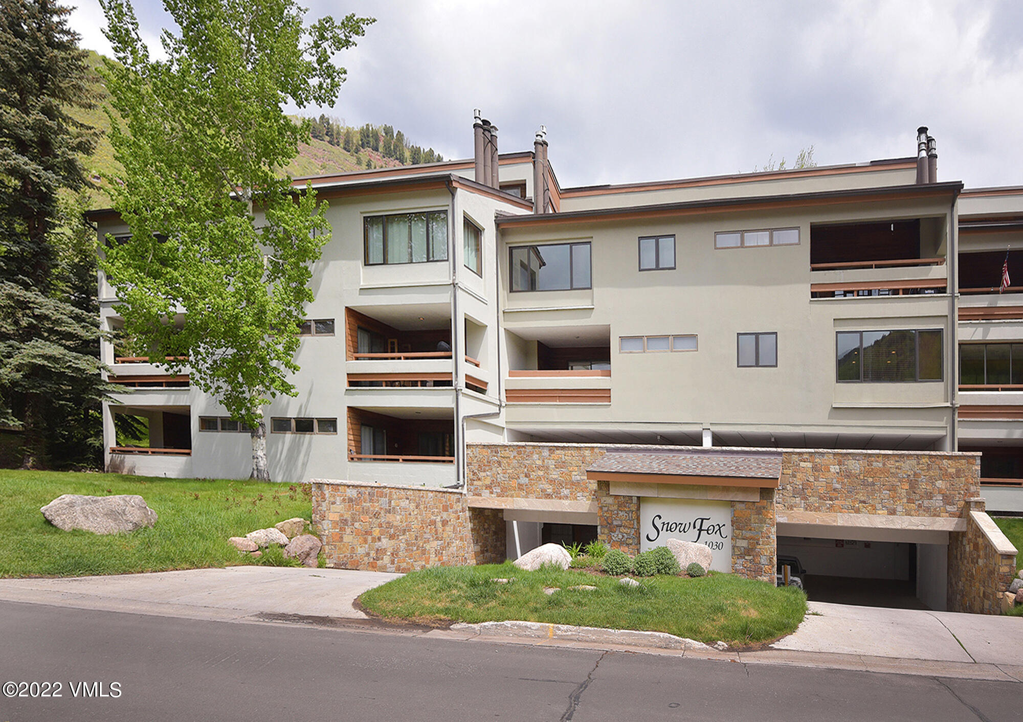 a front view of a house with a garden and garage