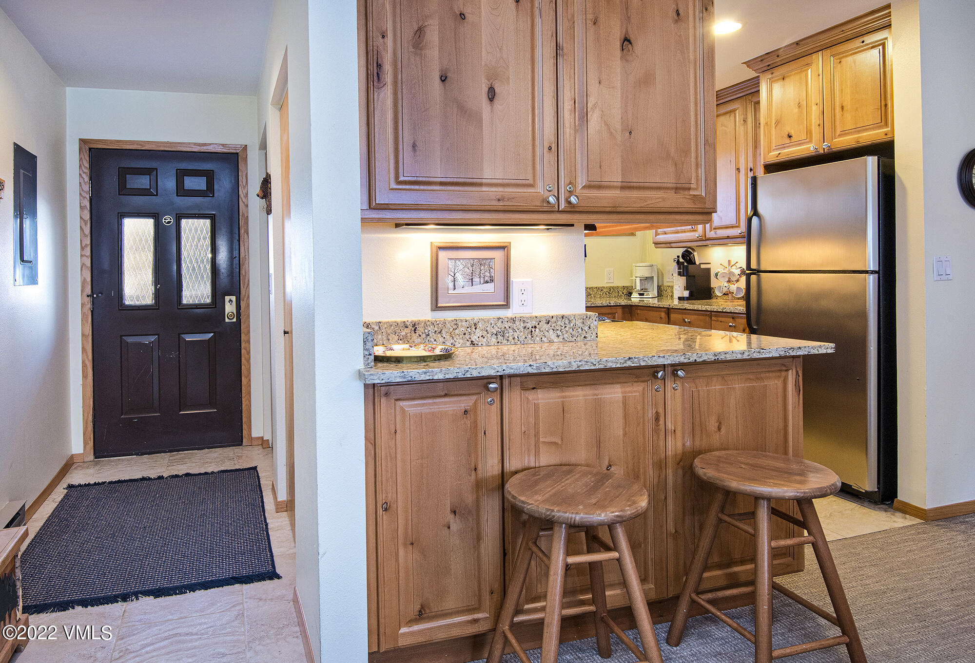 1030 Lions Ridge Loop, Unit 201 Vail, CO 81657 - Photo 11 of 29 a kitchen with a refrigerator and cabinets