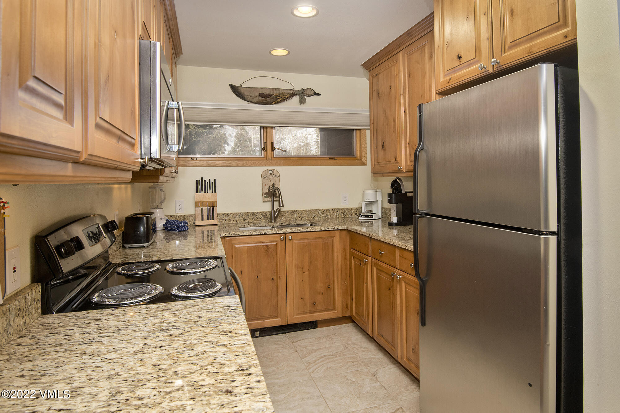 1030 Lions Ridge Loop, Unit 201 Vail, CO 81657 - Photo 12 of 29 a kitchen with stainless steel appliances granite countertop a refrigerator a stove and a sink