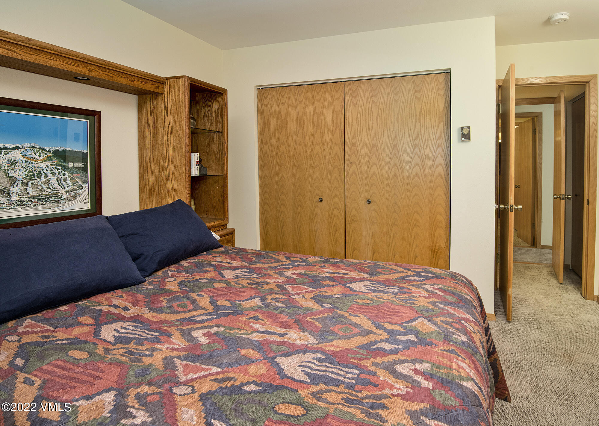 1030 Lions Ridge Loop, Unit 201 Vail, CO 81657 - Photo 17 of 29 a bedroom with a large bed and a painting on the wall