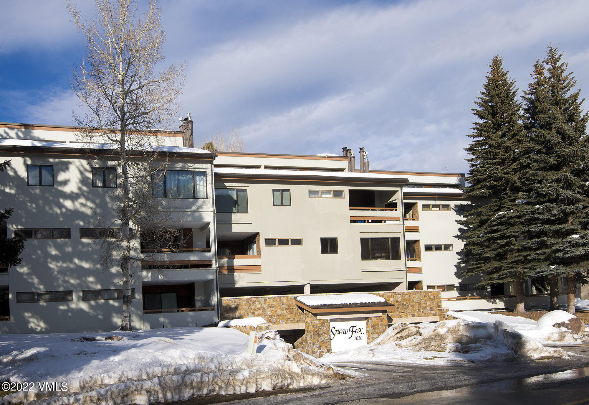 1030 Lions Ridge Loop, Unit 201 Vail, CO 81657 - Photo 25 of 29 a view of a building with a yard