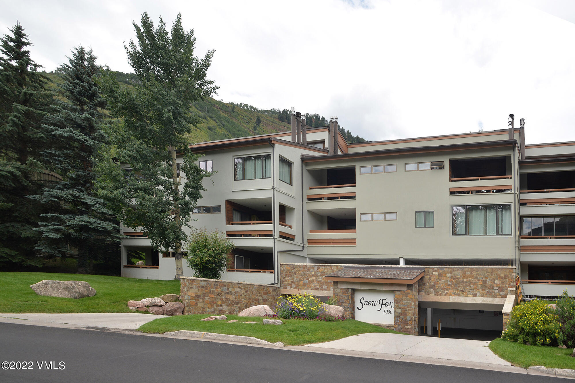 1030 Lions Ridge Loop, Unit 201 Vail, CO 81657 - Photo 29 of 29 a front view of a house with a yard and garage