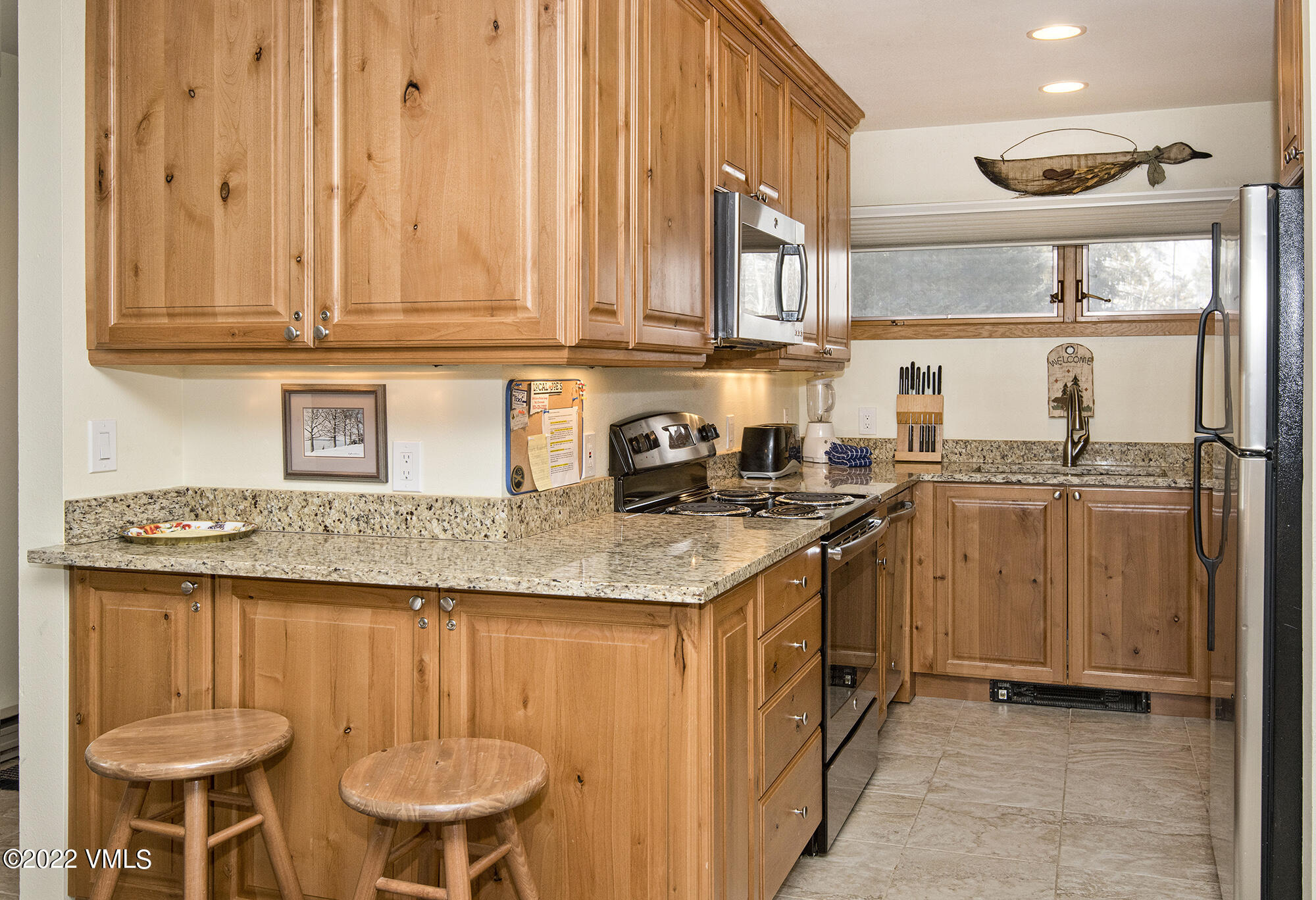 1030 Lions Ridge Loop, Unit 201 Vail, CO 81657 - Photo 10 of 29 a kitchen with stainless steel appliances granite countertop a sink and cabinets