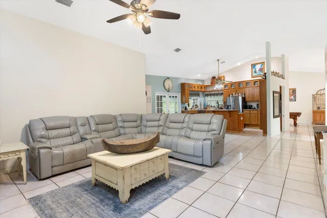 a kitchen with stainless steel appliances granite countertop a refrigerator a stove and a sink with wooden cabinets