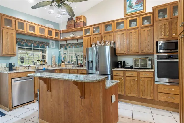 a kitchen with stainless steel appliances granite countertop a sink and a cabinets