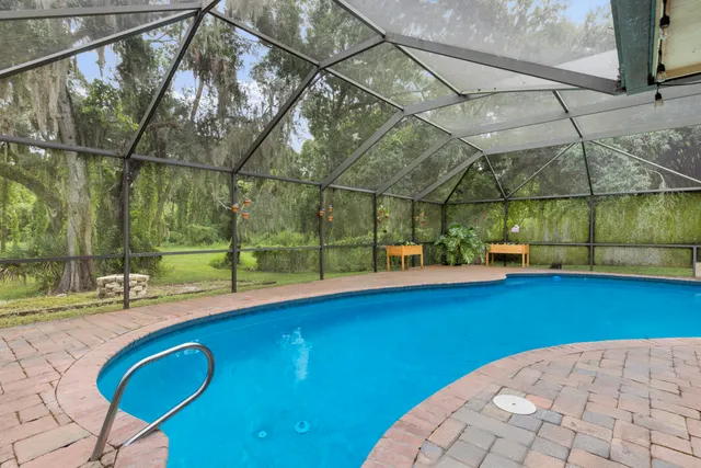 a backyard of a house with table and chairs