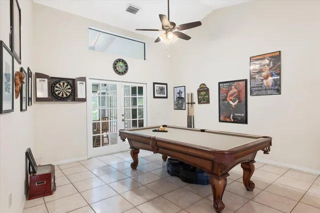 a dining room with wooden floor a chandelier a wooden table and chairs