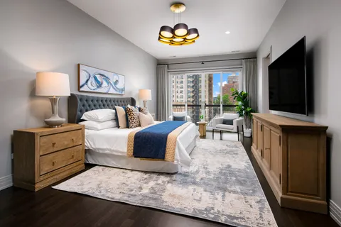 a bedroom with a bed and a flat screen television